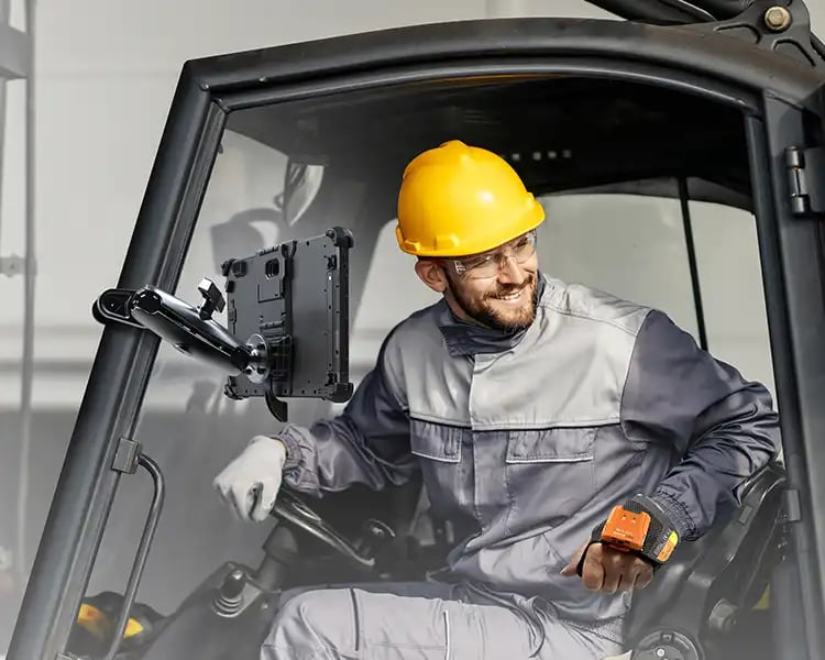 A man in a forklift using a Mobile Demand rugged tablet
