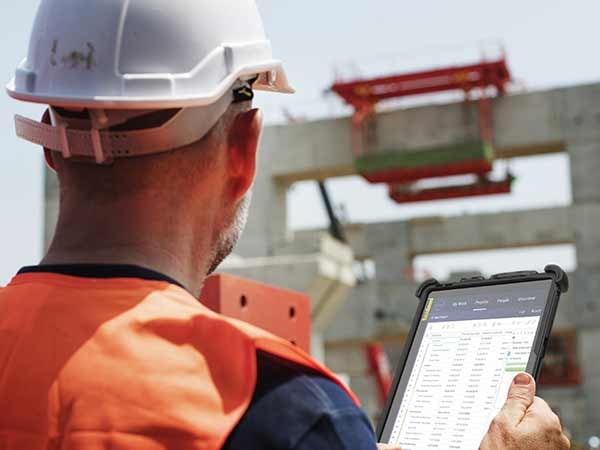 A rugged tablet on a tripod in a construction site