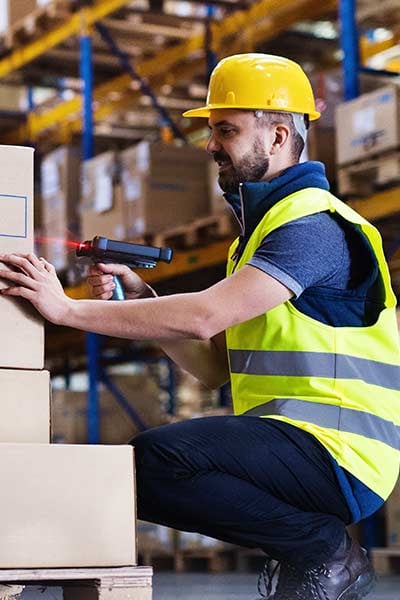 A man scans items in a warehouse