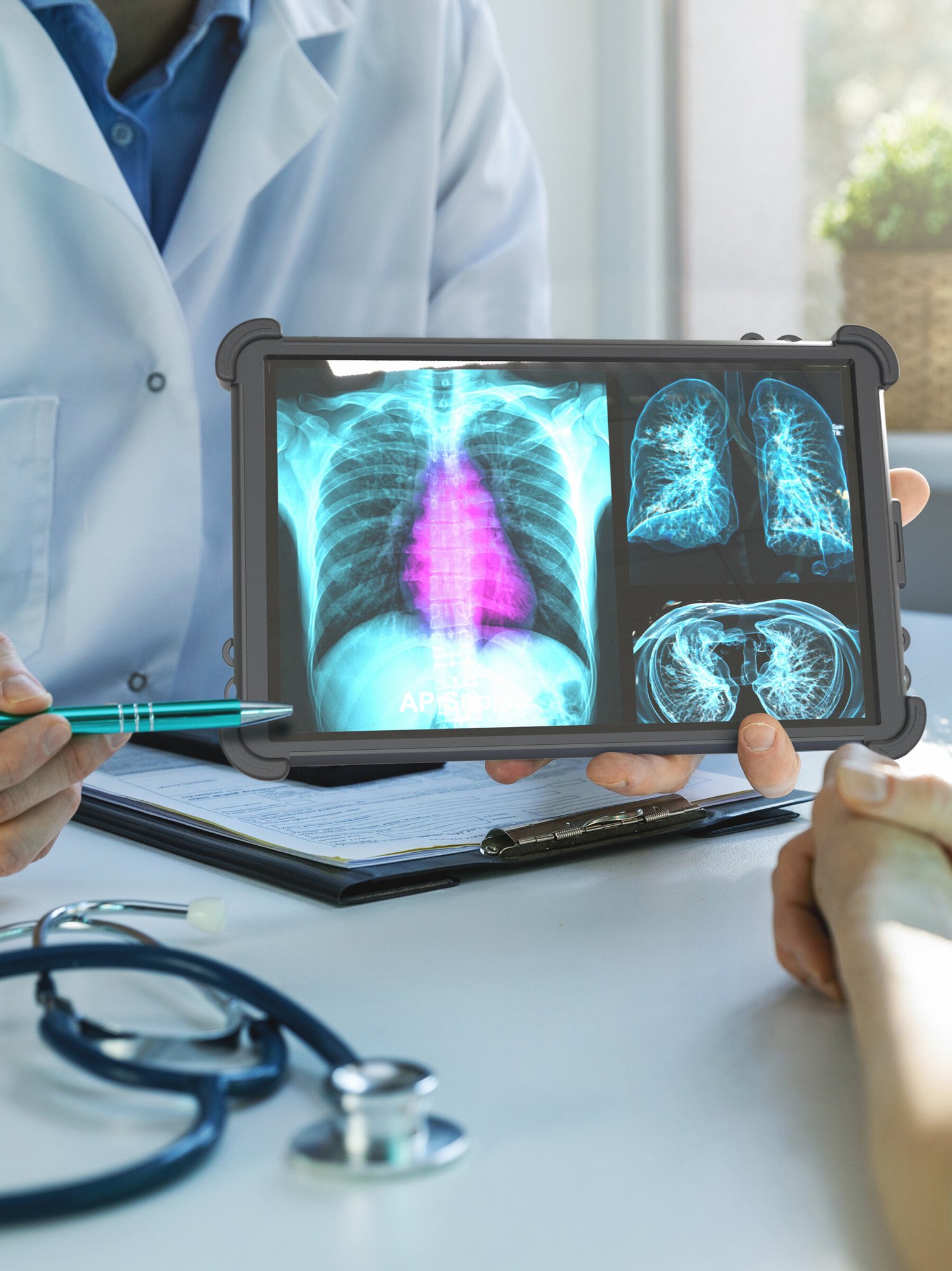 doctor holding rugged tablet showing xray