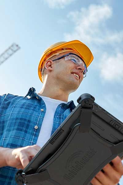 A worker uses a rugged tablet