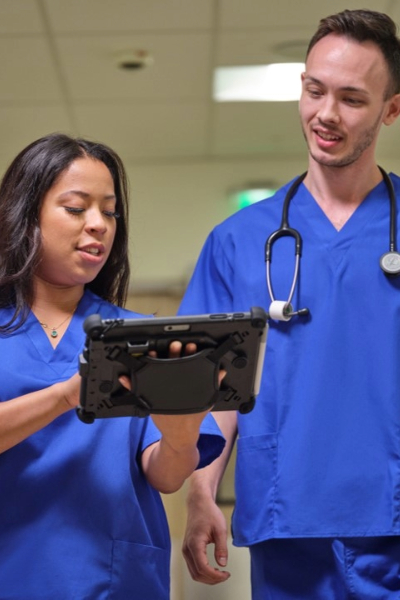 healthcare workers looking at rugged tablet