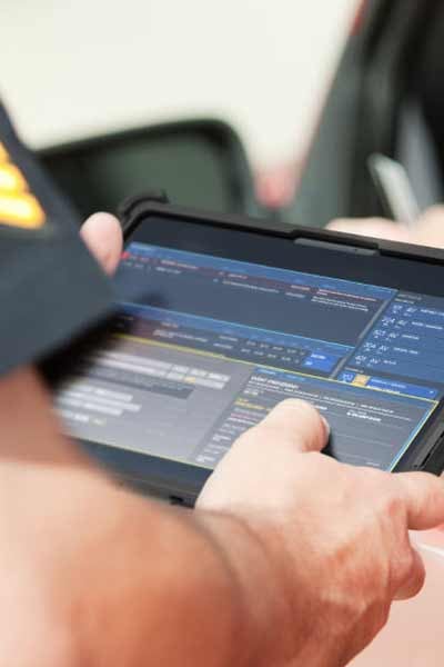 A police officer uses a rugged tablet