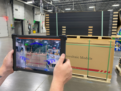 person holding rugged tablet using xdim to dimension a pallet