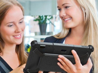 two females looking at sleek rugged tablet