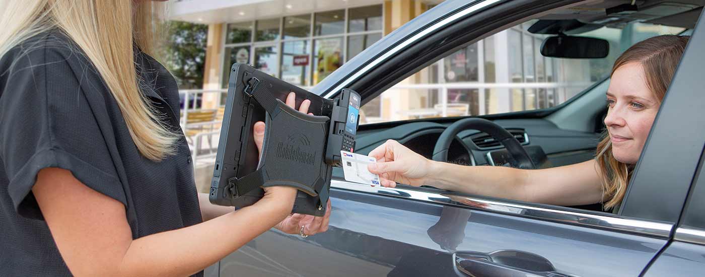 Paying with a card using a rugged tablet through a window