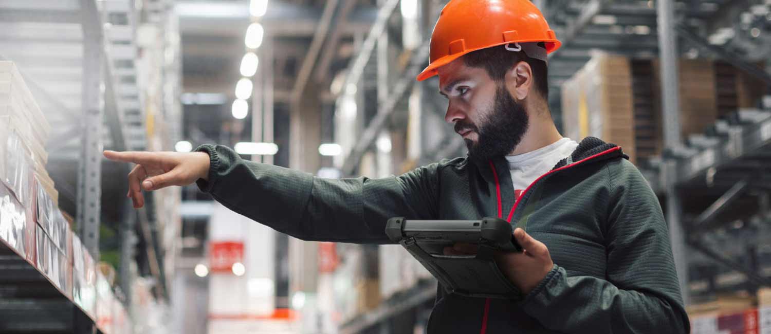 A warehouse worker using a rugged tablet