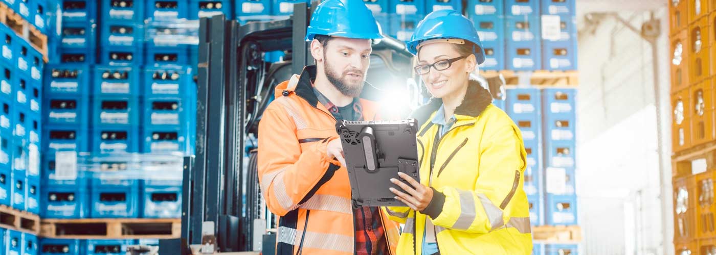 Two workers use a tablet