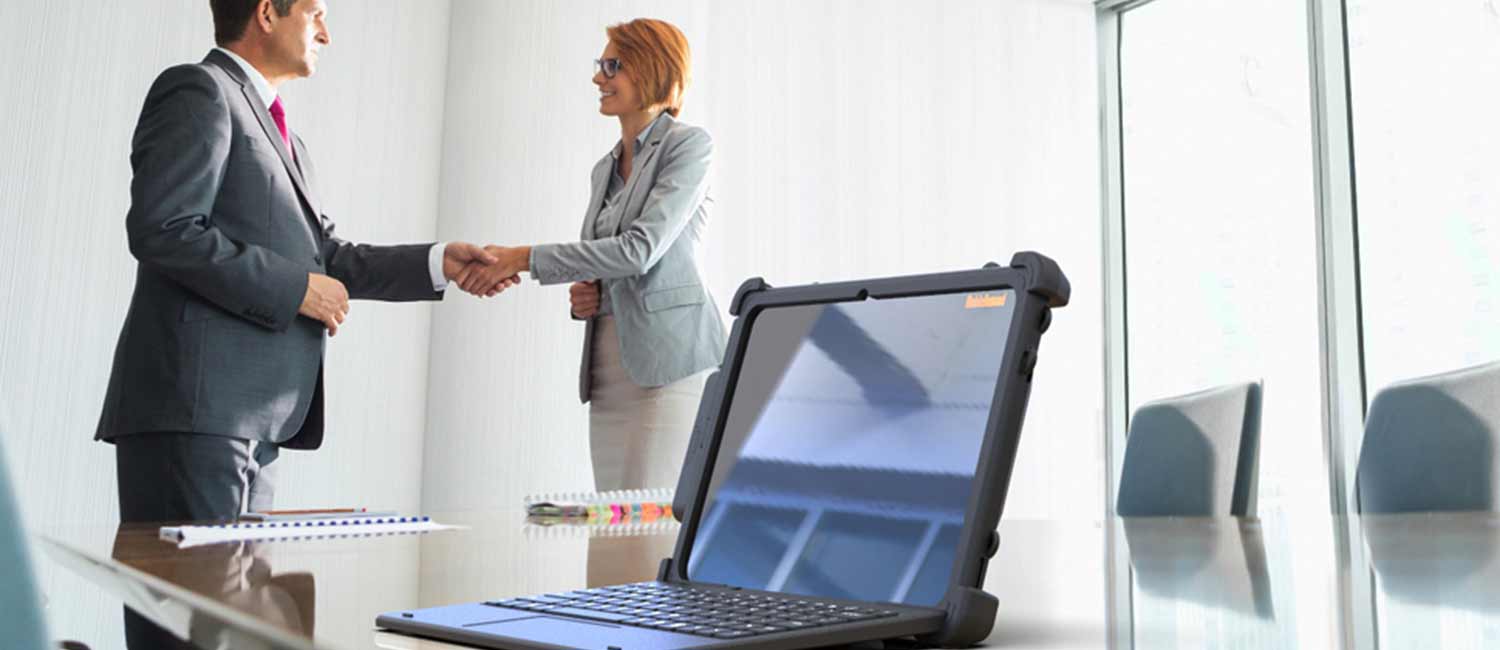 Shaking hands in front of xTablet products