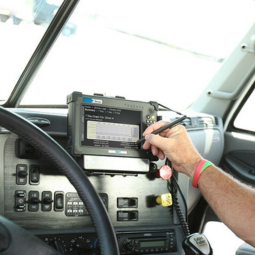 person using stylus on rugged tablet mounted in delivery truck