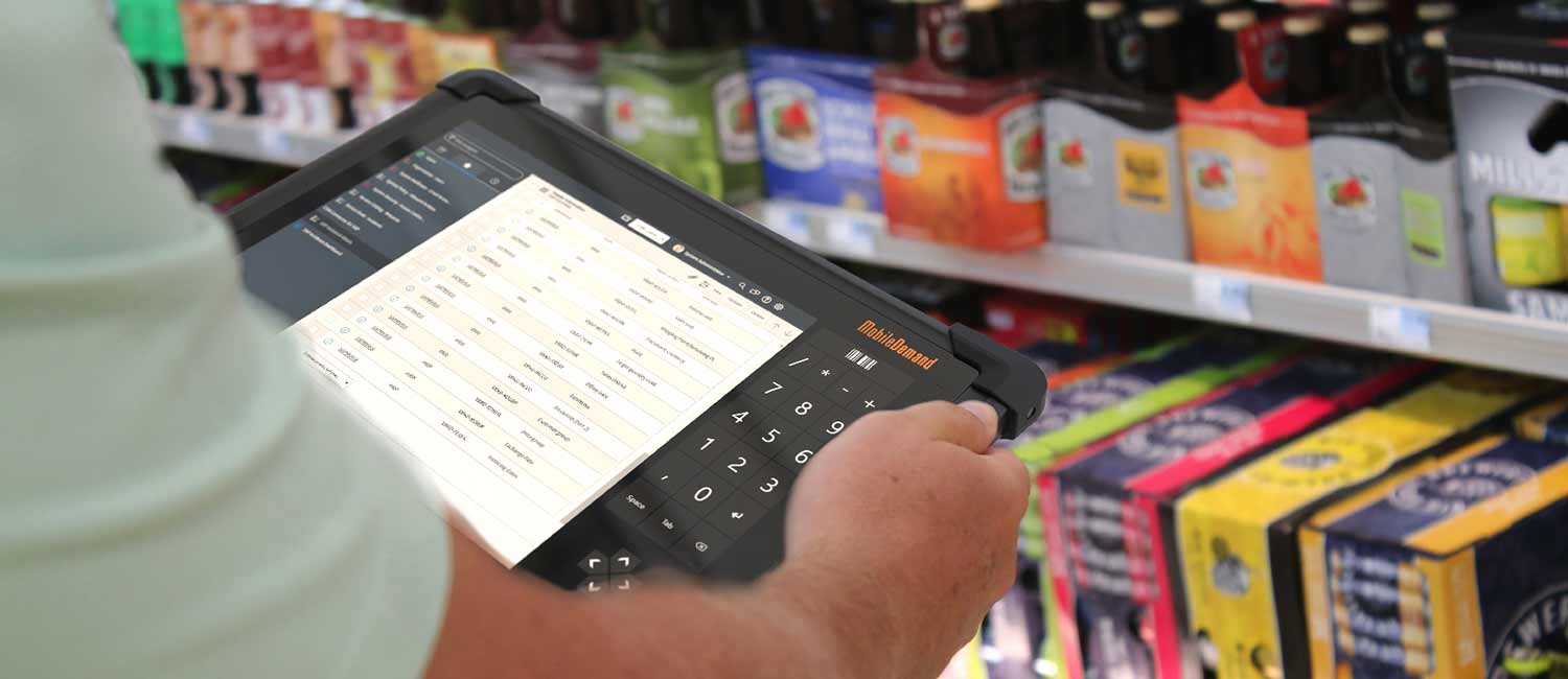 A rugged tablet is used to scan inventory in a super market
