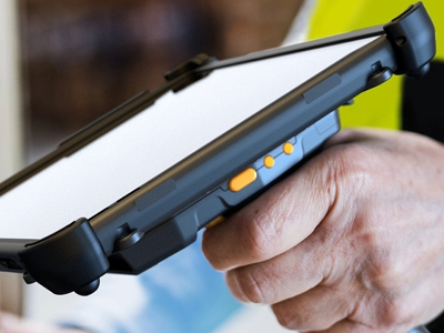 worker holding scan handle with rugged tablet attached