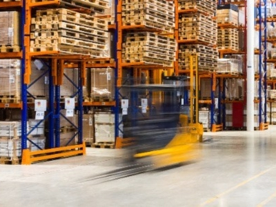 Moving forklift in warehouse