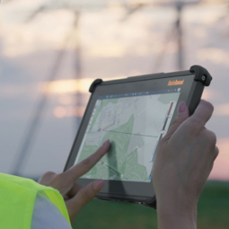 person holding rugged tablets with map on screen