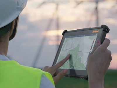 construction worker holding rugged tablet with screen showing map